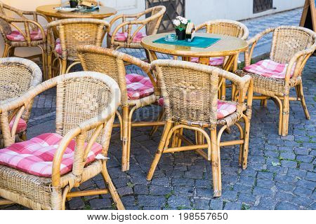 Old fashioned cafe terrace. Tables and wicker chairs in a cafe.