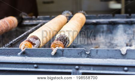 Trdelnik - traditional national czech street desert, baking on the street of Prague.
