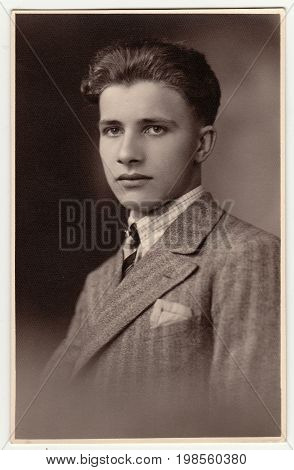 HODONIN, THE CZECHOSLOVAK REPUBLIC - MARCH 21, 1931: A vintage studio photo shows young man wears po
