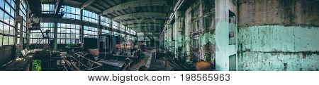 Panoramic shot of abandoned industrial factory in Efremov, Russia. Panorama of a large workshop with old and rusted equipment, toned