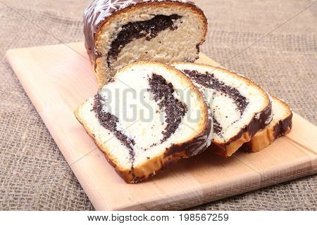 Fresh baked homemade sweet pies, strudel with poppy-seed filling on wooden board