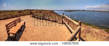 Bench Overlooking The Peaceful And Tranquil Marsh Of Bolsa Chica Wetlands