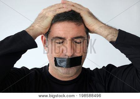 Man With Closed Eyes And Mouth Covered With Masking Tape