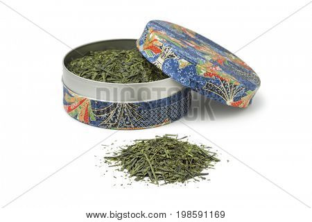 Blue box with Japanese green tea leaves on white background