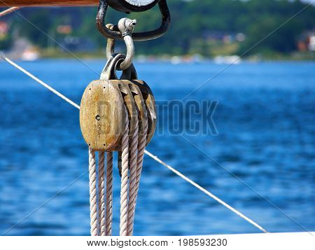 Pulley for sails and ropes made from wood on an old sail boat