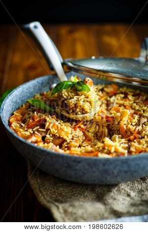 Pilaf with beef, carrots, onions, garlic, pepper and cumin. A traditional dish of Asian cuisine.
