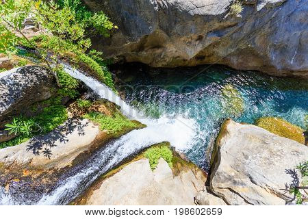 Mountain waterfall with pristine water in Sapadere canyon and pool in it