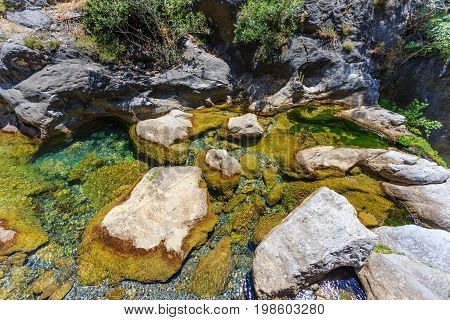 Mountain river with pristine water in Sapadere canyon with stone in it