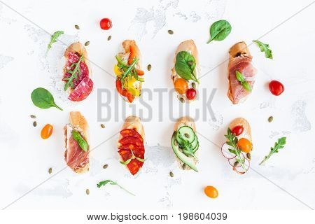 Traditional spanish tapas on white table. Brushetta set. Flat lay top view