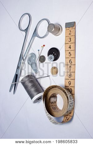 Sewing thread coils needles needle threader scissors push pins thimble tailor's measure