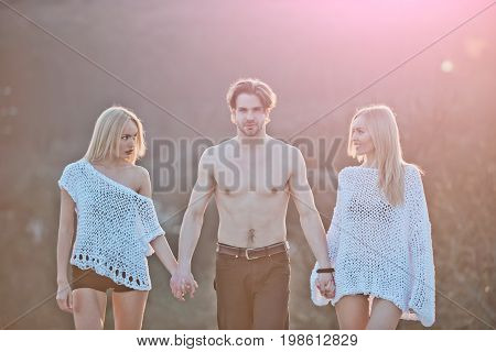 Beauty and fashion. Blonde and guy with athletic chest. Love and romance. Man with muscular body with twins. Girl and women with boyfriend outdoor.