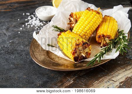 Corn Grilled With Salt And Spices. Dark Background. Fast Food In