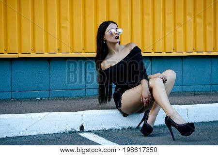 Gorgeous Brunette Girl With A Beautiful Make-up In Fashionable Clothes: A Black Blouse And Shorts Wi