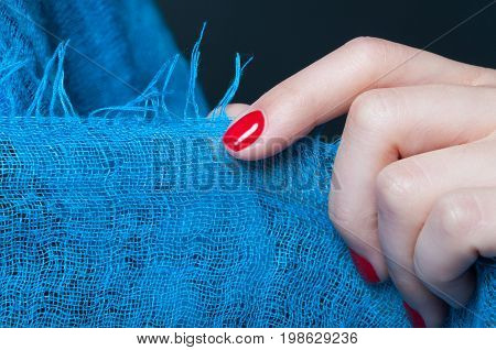 Girl Hand With Feminine Manicure Holding Blue Scarf