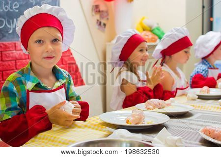 Alchevsk, Ukraine - July 23, 2017: School Cook For Children. Meat Rolls With Cheese Are Prepared.