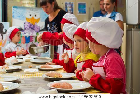 Alchevsk, Ukraine - July 23, 2017: School Cook For Children. Meat Rolls With Cheese Are Prepared.