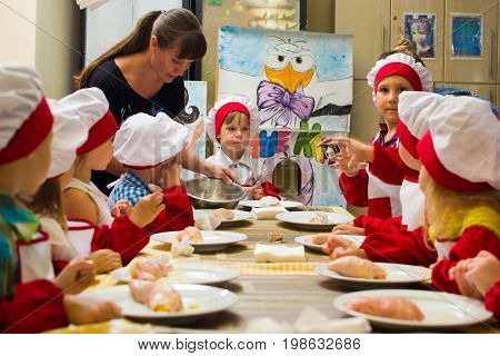 Alchevsk, Ukraine - July 23, 2017: School Cook For Children. Meat Rolls With Cheese Are Prepared.