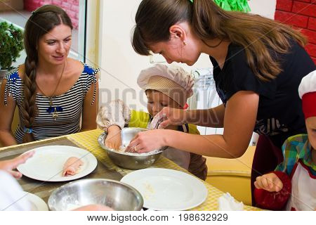 Alchevsk, Ukraine - July 23, 2017: School Cook For Children. Meat Rolls With Cheese Are Prepared.