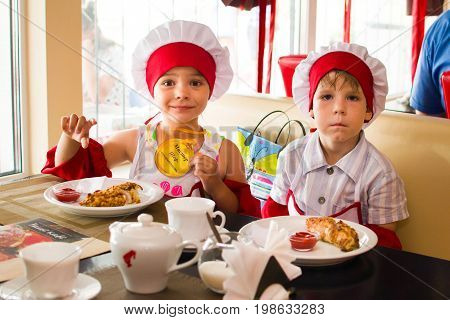 Alchevsk, Ukraine - July 23, 2017: School Cook For Children. Meat Rolls With Cheese Are Prepared.
