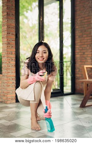 Housework and housekeeping concept. Woman cleaning floor with mop indoors