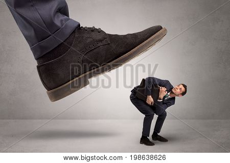 Young businessman illustrated inconsiderable by being trampled