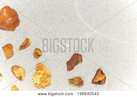 Amber. The Pieces Of Amber In The Sand On The Beach.