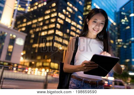 Woman use of digital tablet computer in the evening