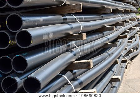 Plastic pipes in stock of finished products stacked in packs
