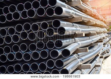 Plastic pipes in stock of finished products stacked in packs