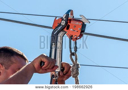 Ukraine Migea - July 30 2017: Automatic brake unit Head Rush Zip Stop for high-speed lines Zipline and for trolley lines. Equipment for safe trolling on a steel cable. Roller for high-speed zipline.