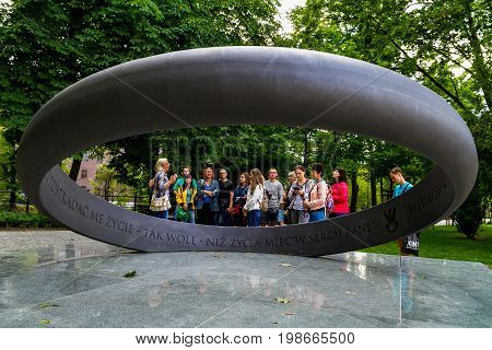 Wroclaw Silesia Poland - July 25 2017: Tourists stand near the monument to captain Witold Pilecki in one of the city parks.