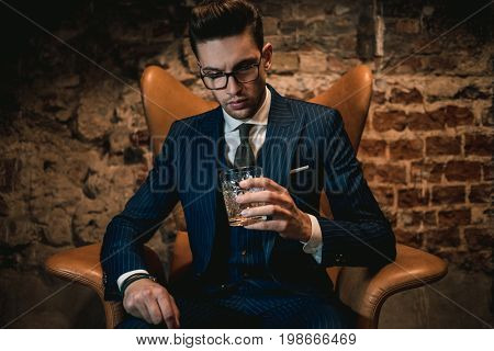 Sharp dressed dandy in a chair