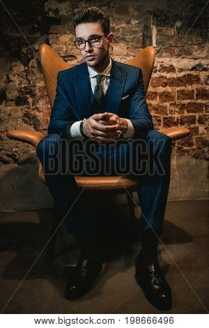 Sharp dressed dandy in a chair