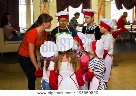 Alchevsk, Ukraine - July 30, 2017: School Cooks For Children. Learn To Cook Pasta With Sausages