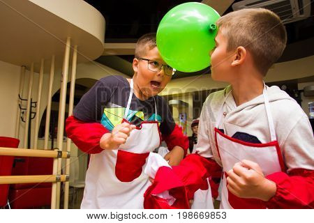 Alchevsk, Ukraine - July 30, 2017: School Cooks For Children. Learn To Cook Pasta With Sausages