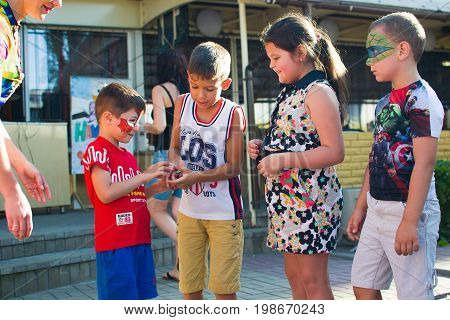 Alchevsk, Ukraine - July 27, 2017: Happy Children Play With Animators In Summer
