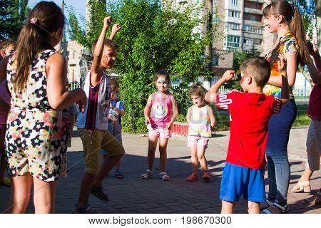 Alchevsk, Ukraine - July 27, 2017: Happy Children Play With Animators In Summer