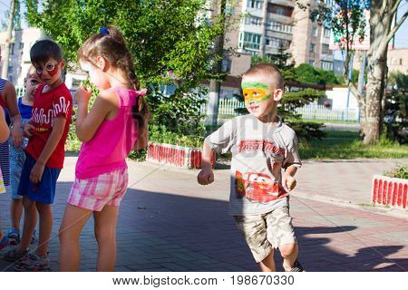 Alchevsk, Ukraine - July 27, 2017: Happy Children Play With Animators In Summer