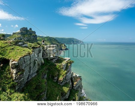 Hiker on the headland in Valley of the Rocks on South West coast path near Lynmouth