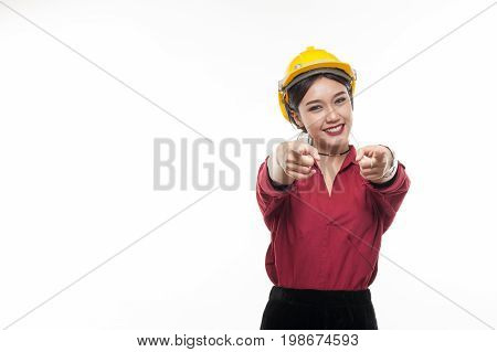 Asian woman engineer in red shirt and yellow safty cap pointing front with happy emotion. People gesturing in business and enginerring concept