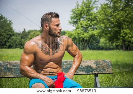 Muscular Handsome Shirtless Hunk Man Outdoor in City Park. Showing Healthy Muscle Body