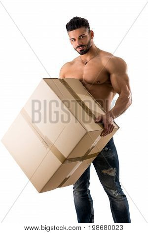 Attractive shirtless muscular man holding and carrying big cardboard box, isolated on white, looking at camera
