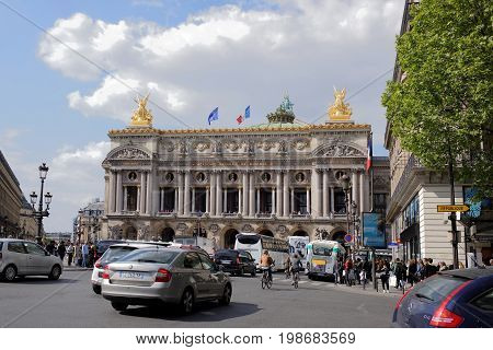 ParisFrance- April 29 2017: View of the Avenue de l Opera with the Palais Garnier opera. On the street pedestrians and moving vehicles