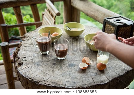 Breakfast hot chocolate for drink with egg on the wood table.