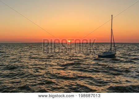 boat on the sea with the sun setting