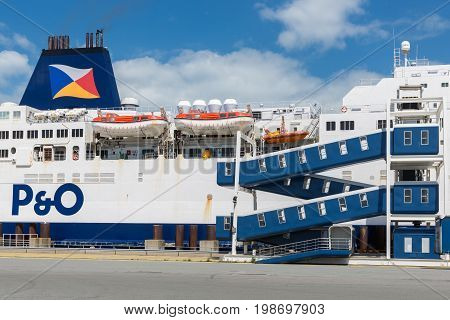 HARBOR CALAIS FRANCE - JUNE 07 2017: Ferry to England moored for embarking or disembarking at harbor gate in Calais France
