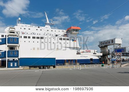 HARBOR CALAIS FRANCE - JUNE 07 2017: Ferry to England moored for embarking or disembarking at harbor gate in Calais France