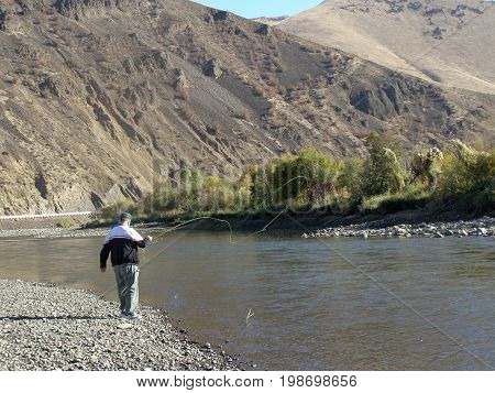 Man fly fishing in Yakima River canyon