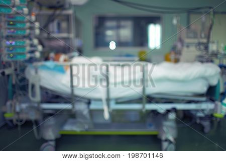 ICU with patient in bed unfocused medical background.
