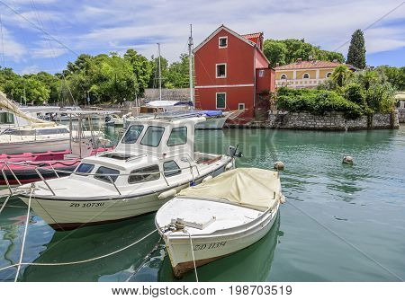 ZADAR, CROATIA - JULY 14, 2017: Pleasure boats and fishing boats on the pier in Fosa Bay in the spa town of Zadar in Croatia.